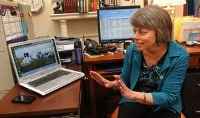 Linda at desk, excited about Dog Pearls footage - photo by John Fletcher